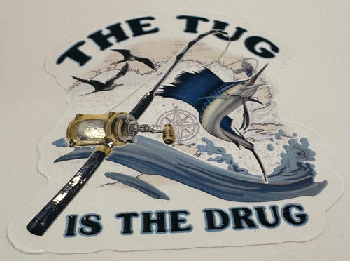 The Tug Is The Drug sailfish embossed fishing sticker with rod, reel, waves, and offshore artwork.