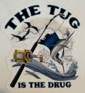 The Tug Is The Drug sailfish embossed fishing sticker with rod, reel, waves, and offshore artwork.